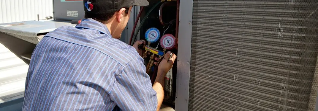 HVAC technician servicing a condenser unit in South Pasadena