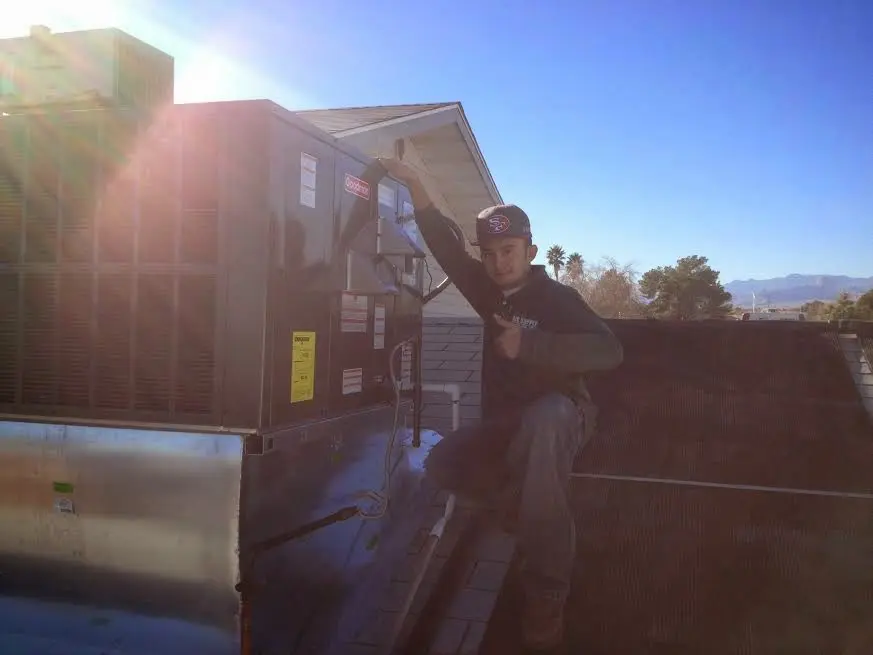 HVAC technician performing Air Duct Repair on a rooftop unit in South Pasadena
